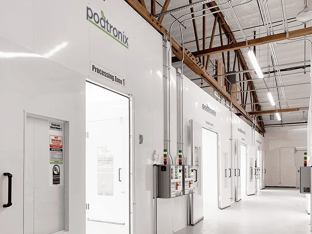 Multi-zone facility corridor with side-by-side Processing and Extraction Zones, each with dedicated SMART control panels and stack lights.