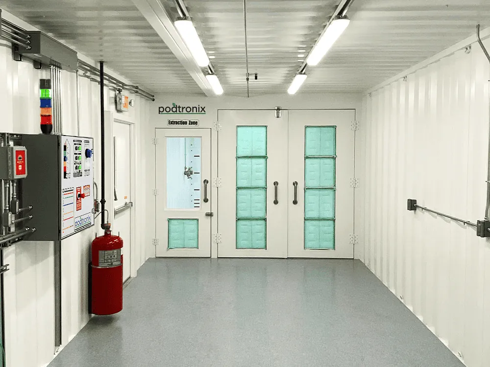 Interior view of the Extraction Zone with self-closing, self-sealing door, fire extinguisher, and interior strobe & alarm.