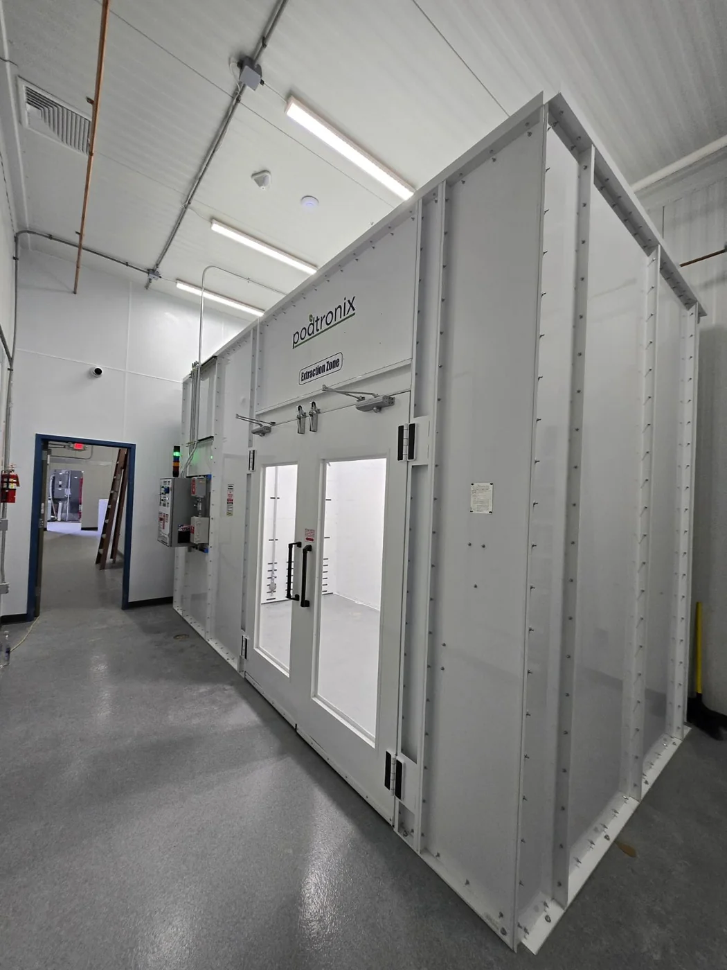 Modular room installed within a larger production facility